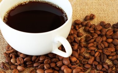Cup of coffee with coffee beans clipart