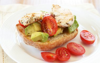 Tasty avocado, tomato and chicken bruschetta clipart