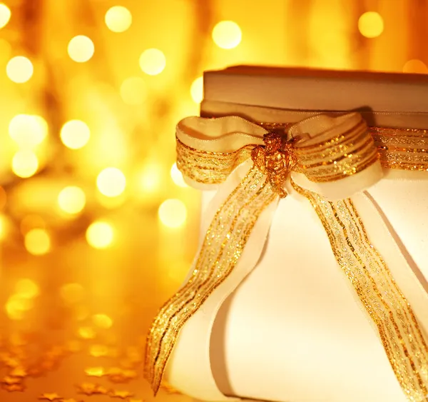 Gift over abstract Christmas lights — Stock Photo, Image