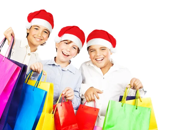 Glückliche Weihnachtsmänner mit Geschenken — Stockfoto