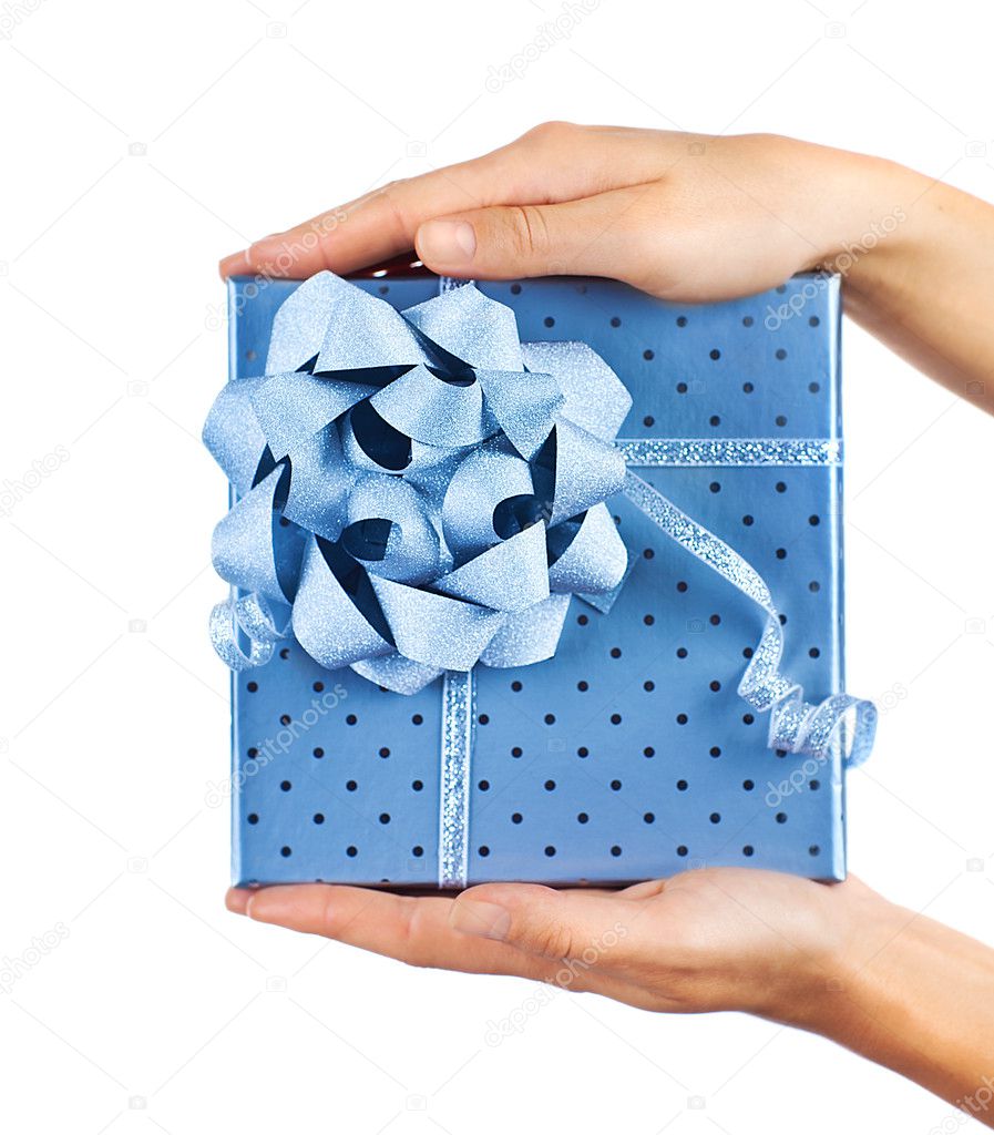 Female hands holding blue gift box