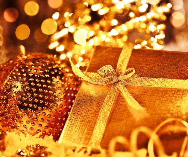 Golden Christmas gift with baubles decorations — Stock Photo, Image