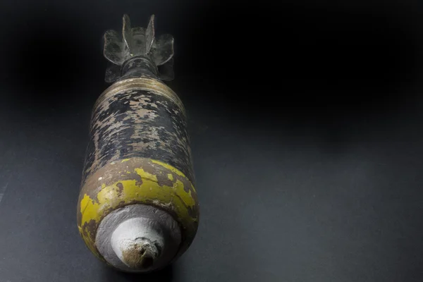 Mortar bomb black and yellow very old and rusty — Stock Photo, Image