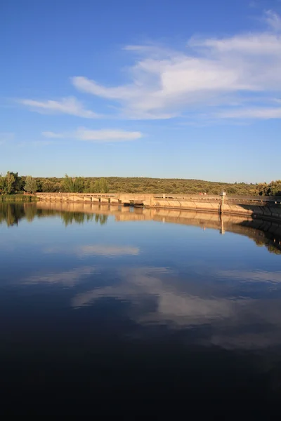 stock image Reflexes in small dam at sunset