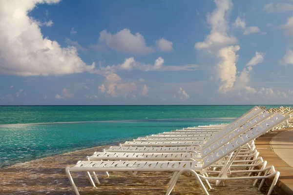 Sillas de playa en una piscina tropical en las Bahamas — Foto de Stock