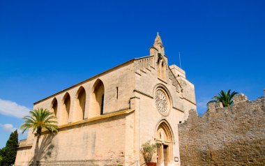 Alcudia Sant Jaume church near roman castle wall Mallorca clipart