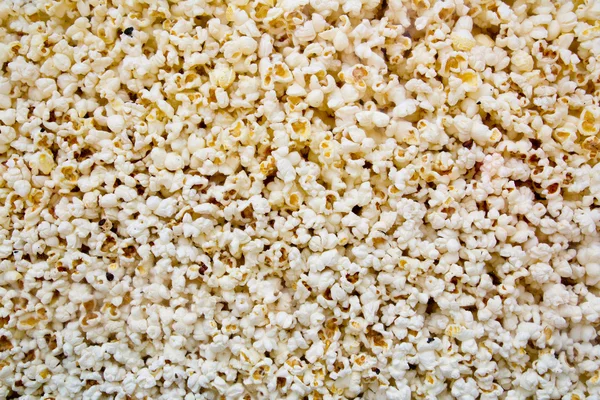 Kukurydzy popcorn tekstura widok ze szkła — Zdjęcie stockowe
