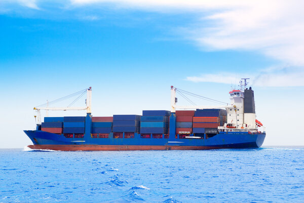 Cargo ship with containers in dep blue sea