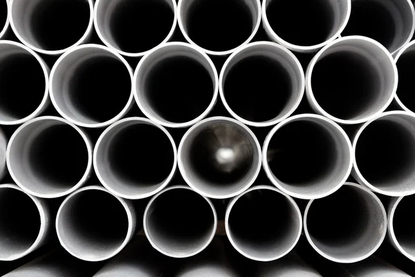 Gray PVC tubes plastic pipes stacked in rows — Stock Photo, Image