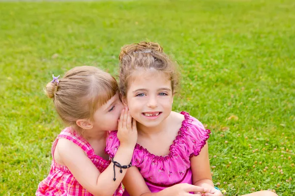 Children girl sister friends whispering ear — Stock Photo, Image