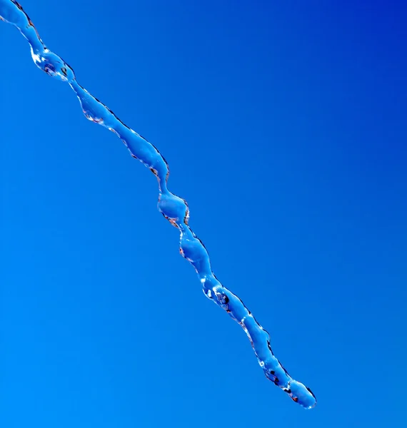 Water splash in blue sky background — Stock Photo, Image
