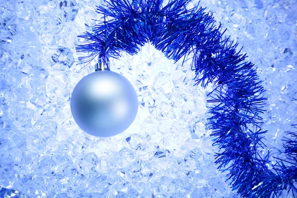 Christmas silver bauble on blue winter ice — Stock Photo, Image