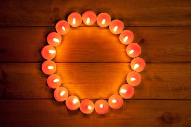 Candles cirlce shape on warm golden wood clipart