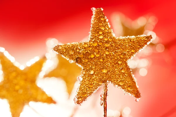 Boże Narodzenie złote krople gwiazdy w kolorze czerwonym — Zdjęcie stockowe
