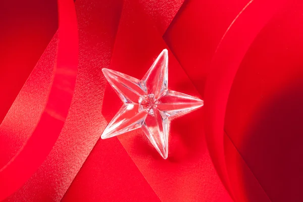 Christmas glass star on red ribbon — Stock Photo, Image