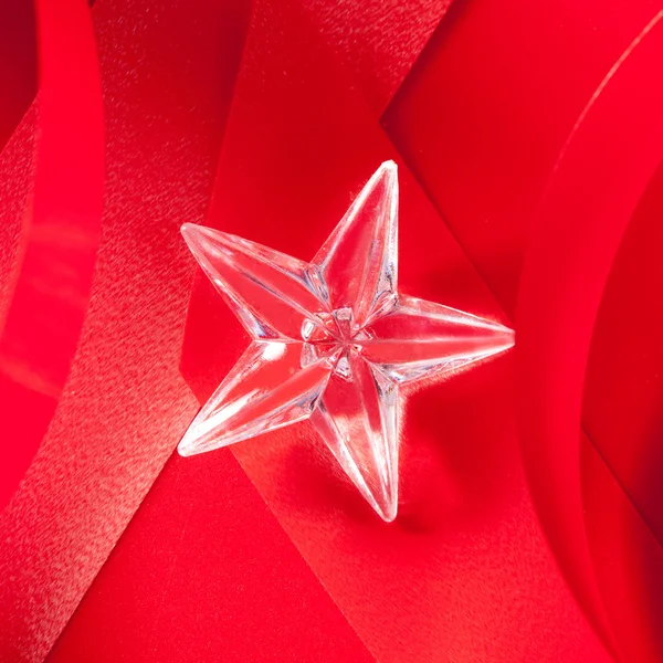 Christmas glass star on red ribbon — Stock Photo, Image