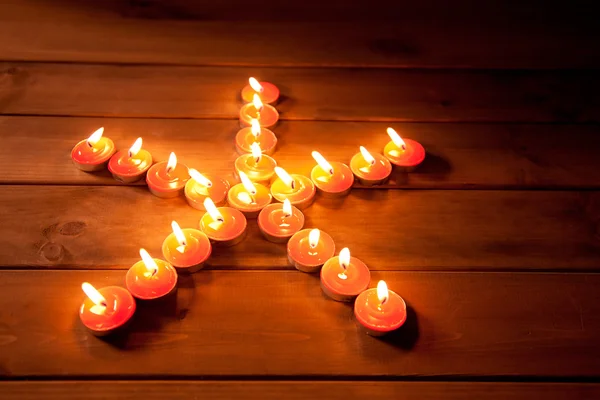 Christmas candles pentagram star on wood — Stock Photo, Image