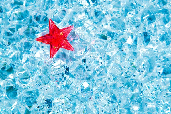 Christmas red glass star on cold blue ice — Stock Photo, Image