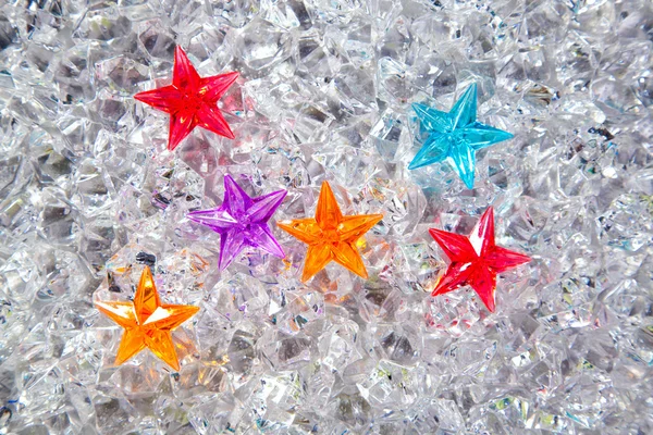 Christmas colorful glass stars on cold ice — Stock Photo, Image
