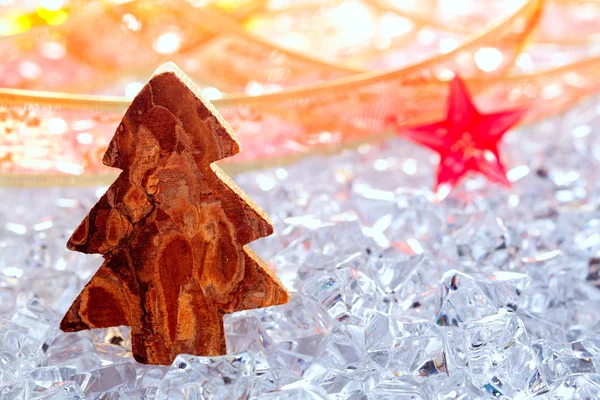 Christmas tree with bark wood on winter ice — Stock Photo, Image