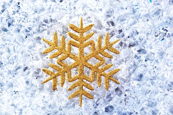 Chritmas golden snowflake symbol on ice — Stock Photo, Image