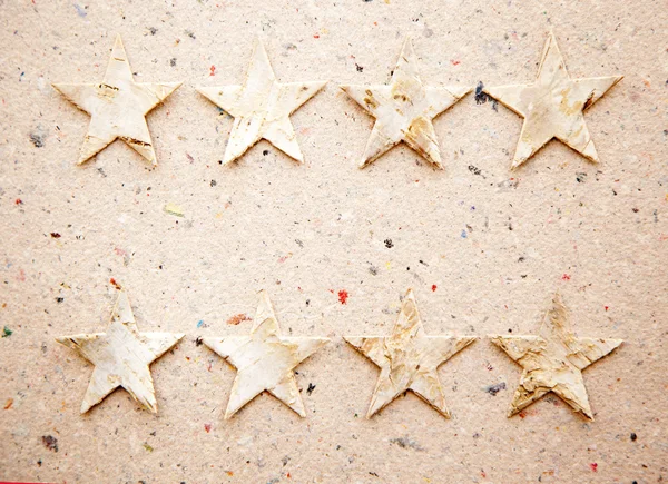 Christmas stars on recycled paper background — Stock Photo, Image