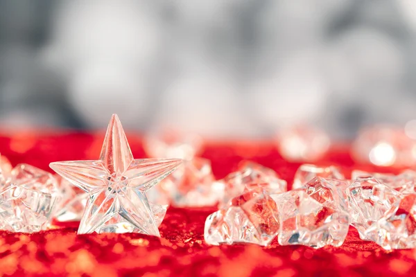 Christmas crystal star on ice cubes — Stock Photo, Image