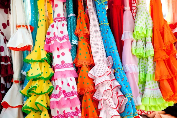 Colorful gipsy dresses in rack hanged in Spain — Zdjęcie stockowe