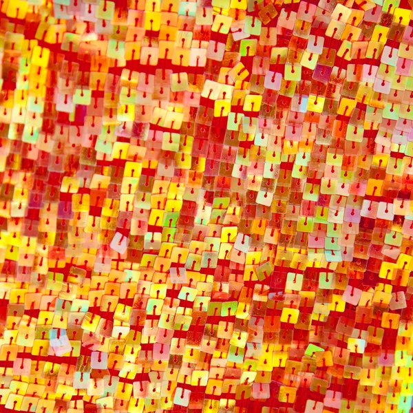 Colorful red yellow sequins with square shape — Stock Photo, Image