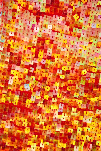 Coloridas lentejuelas rojas amarillas con forma cuadrada — Foto de Stock