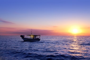 Blue sea sunrise with sun in horizon clipart