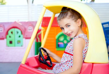 Children girl driving a toy car clipart