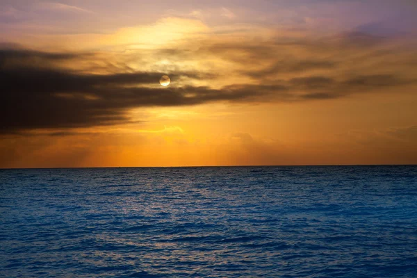 Golden sunrise with sun and clouds over sea — Stock Photo, Image