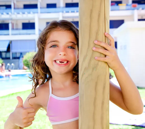 Petite fille dentelée ok geste dans le jardin de la piscine — Photo