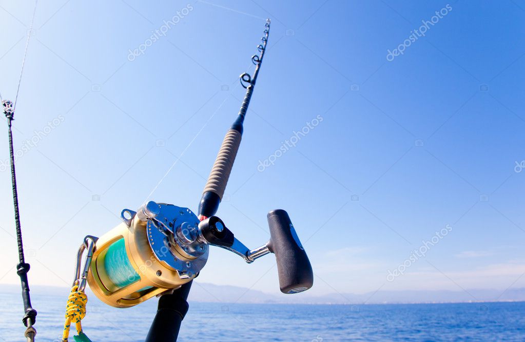 Trolling fishing boat rod and golden saltwater reels — Stock Photo ©  lunamarina #5506238