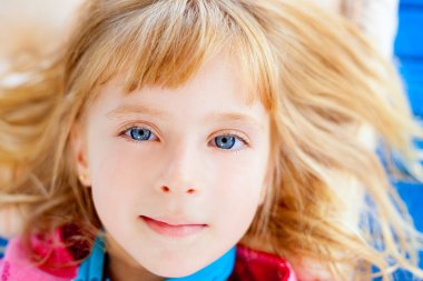 Beautiful blond blue eyes girl lying clipart