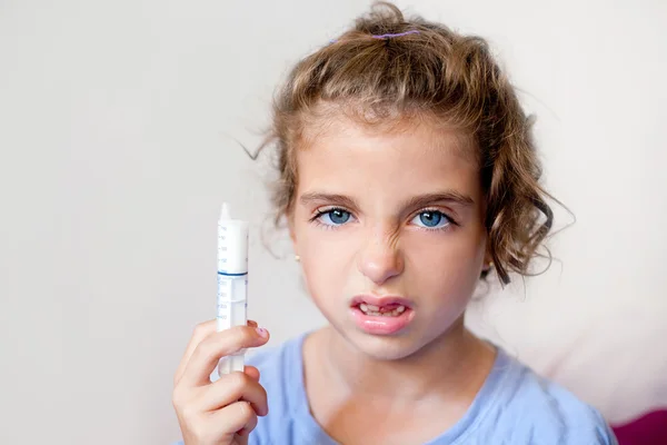 Unhappy kid girl with syringe medicine dose — Stock Photo, Image