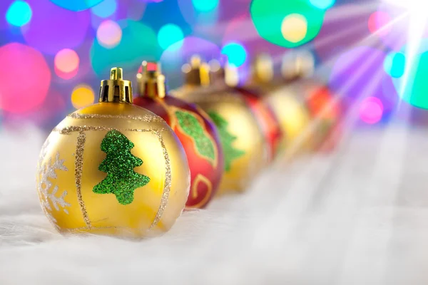 Christmas golden red baubles in a row with lights — Stock Photo, Image