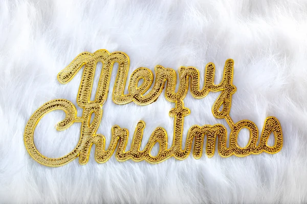 Joyeux Noël écrit en or sur une fourrure blanche — Photo