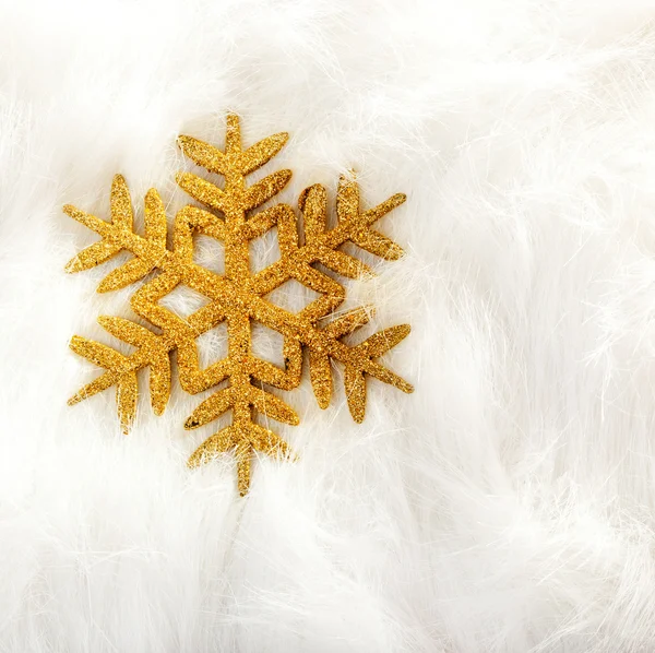 Christmas golden snowflake over white fur — Stock Photo, Image
