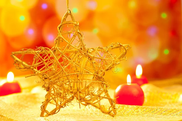 Christmas golden star candles in blurred lights — Stock Photo, Image