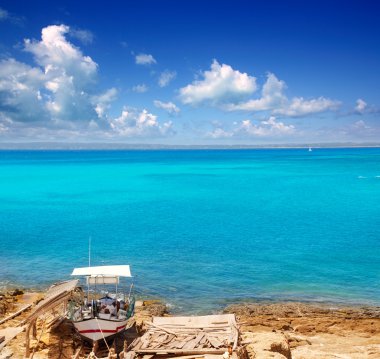 Formentera Es Ram beach with traditional boat clipart