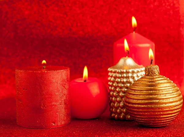 Christmas candles group on red glitter — Stock Photo, Image