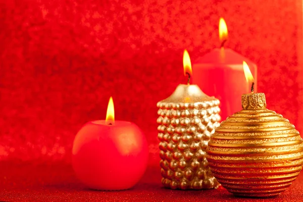 Christmas candles group on red glitter — Stock Photo, Image