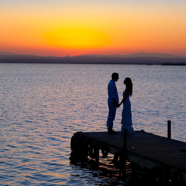 Coppia innamorata torna silhouette luce al lago — Foto Stock