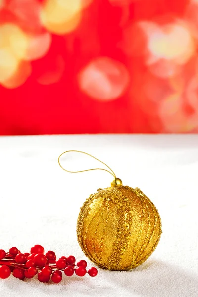 Christmas card of golden bauble berries on snow — Stock Photo, Image
