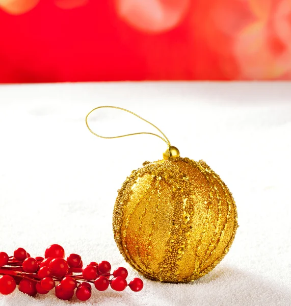 Christmas card of golden bauble berries on snow — Stockfoto