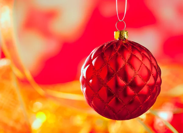 Noel kartı üzerinde kırmızı capiton biblo, bulanıklık — Stok fotoğraf