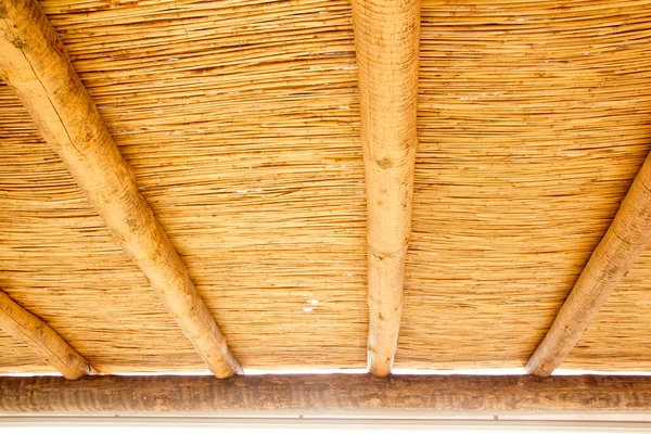 Тростниковый люк с круглым деревянным брусом — стоковое фото