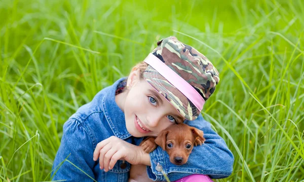 Liten flicka med hundvalp maskot mini pinscher — Stockfoto